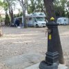 Area di campeggio con camper e fontanella.